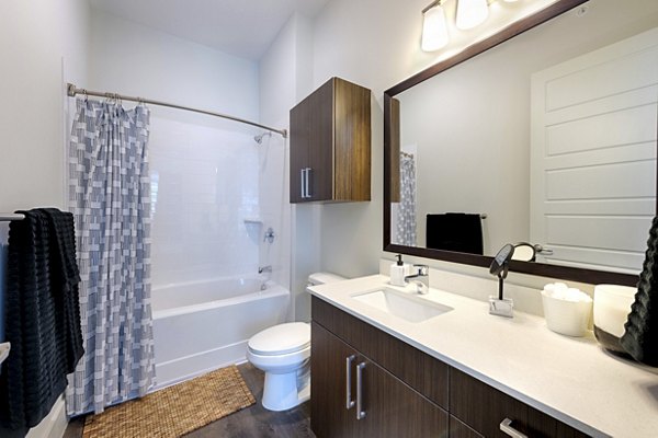 Bathroom with sleek fixtures and modern lighting at Millennium Music Row Apartments
