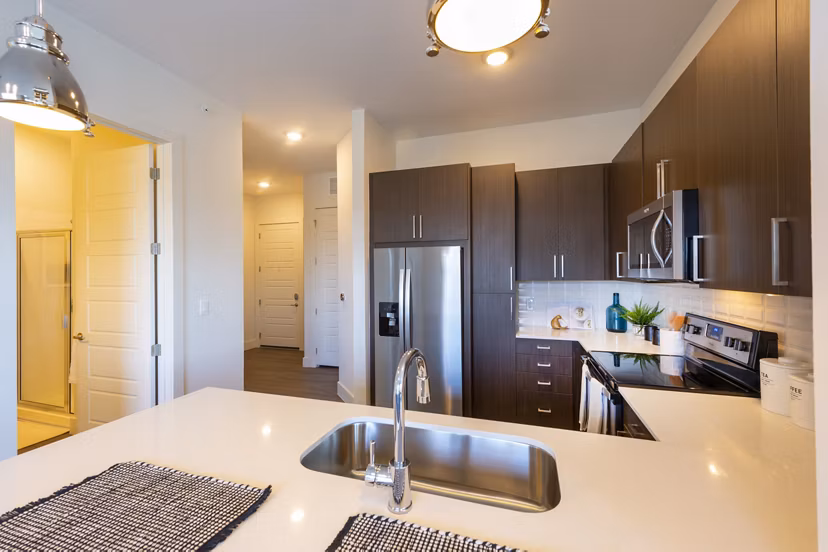Modern kitchen with stainless steel appliances at Millennium Music Row Luxury Apartments