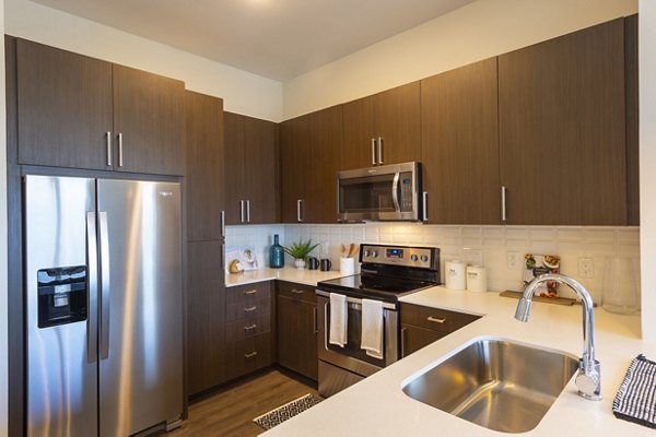 Modern kitchen featuring stainless steel appliances at Millennium Music Row Apartments