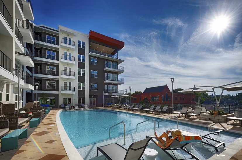 Rooftop swimming pool with city skyline views at Millennium Music Row Apartments