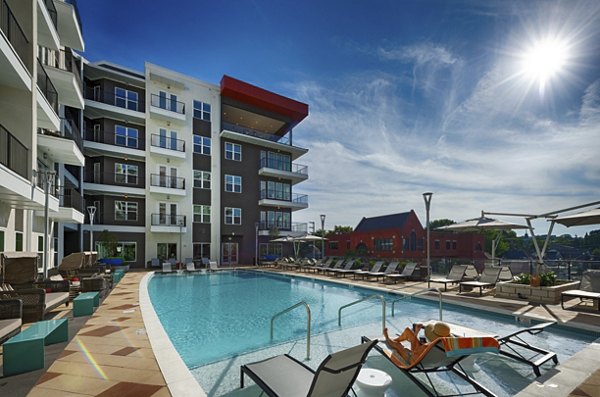 Rooftop swimming pool with city skyline views at Millennium Music Row Apartments
