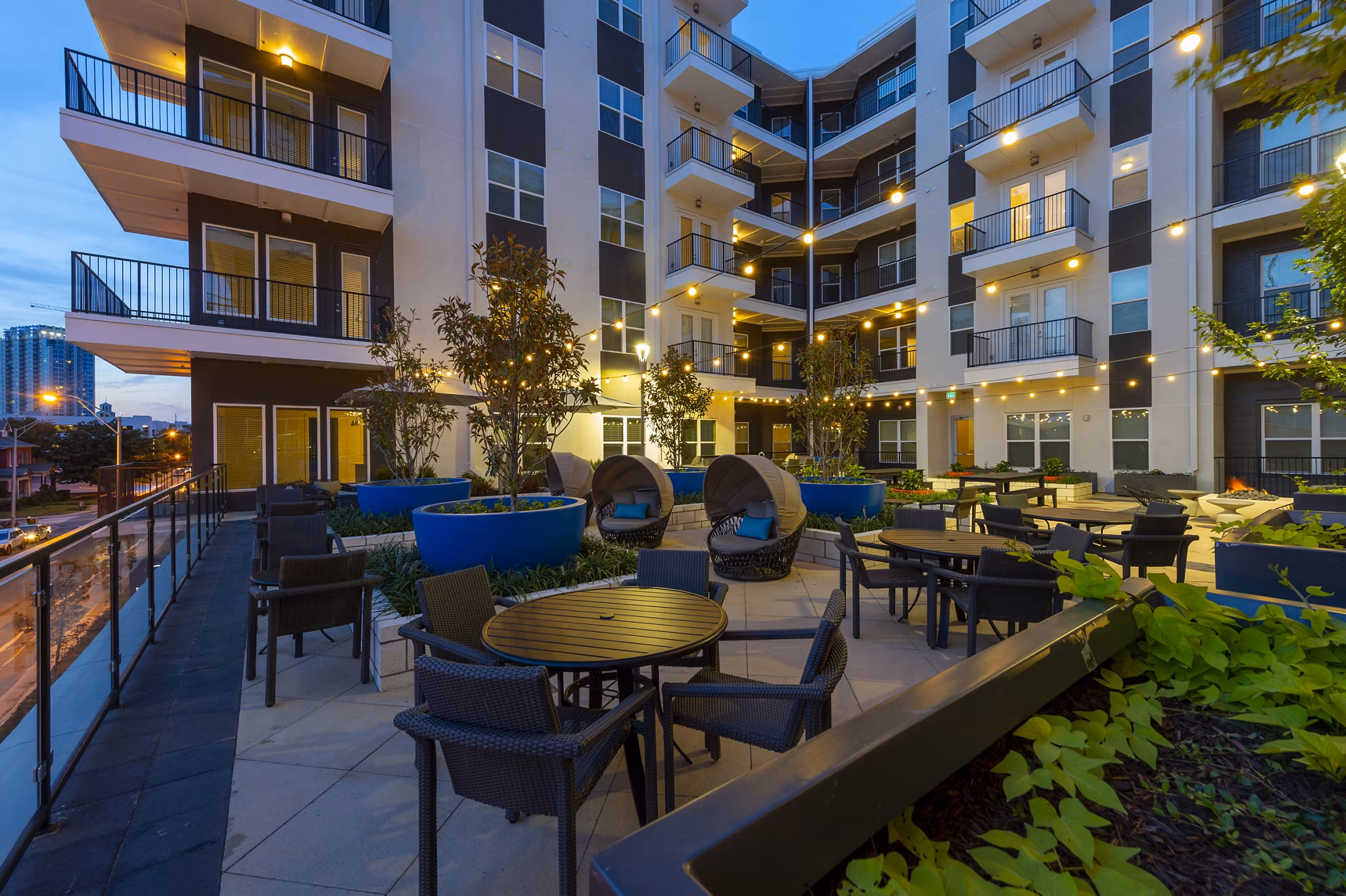 Courtyard with lush greenery and seating at Millennium Music Row Apartments