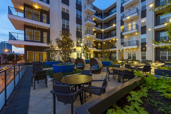 Courtyard with lush greenery and seating at Millennium Music Row Apartments