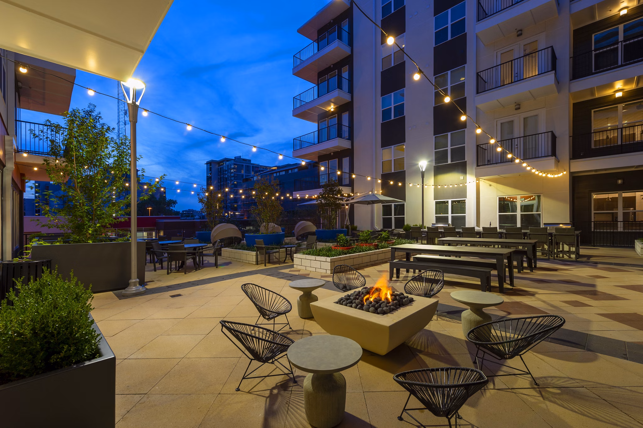 Fire pit with cozy seating at Millennium Music Row luxury apartments, ideal for outdoor relaxation in vibrant Nashville community