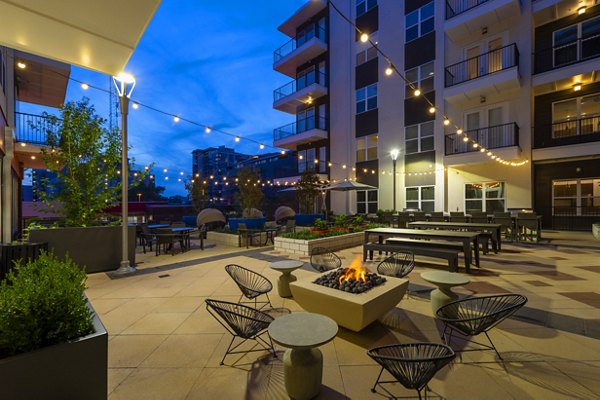 Fire pit with cozy seating at Millennium Music Row luxury apartments, ideal for outdoor relaxation in vibrant Nashville community