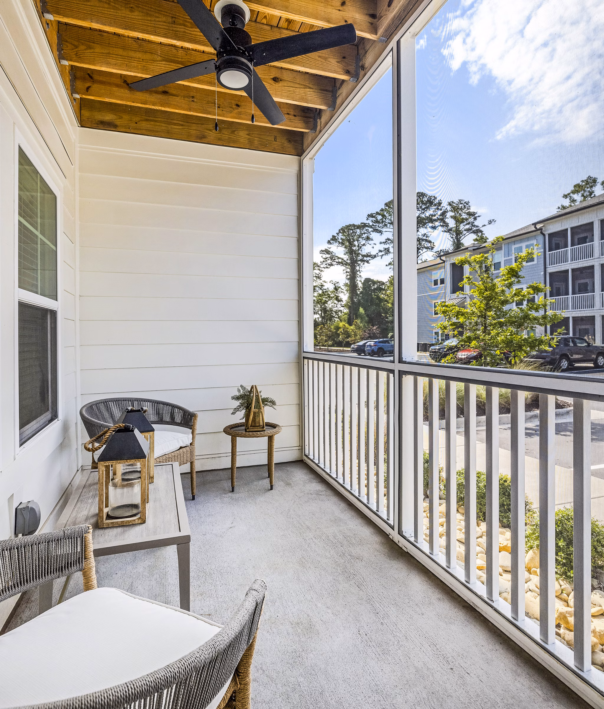 Cozy patio with modern furniture overlooking lush landscape at Eventide Apartments