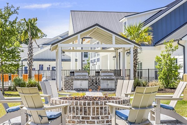 Grill area and fire pit at Eventide Apartments, a luxury feature for residents to enjoy socializing and outdoor dining experiences