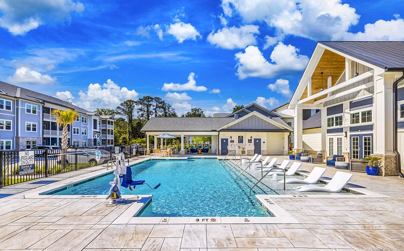 Poolside leisure at Eventide Apartments: Luxury relaxation area featuring a serene pool environment for residents to enjoy