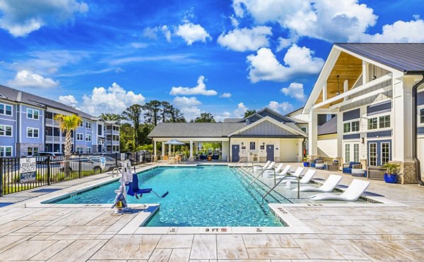 Poolside leisure at Eventide Apartments: Luxury relaxation area featuring a serene pool environment for residents to enjoy