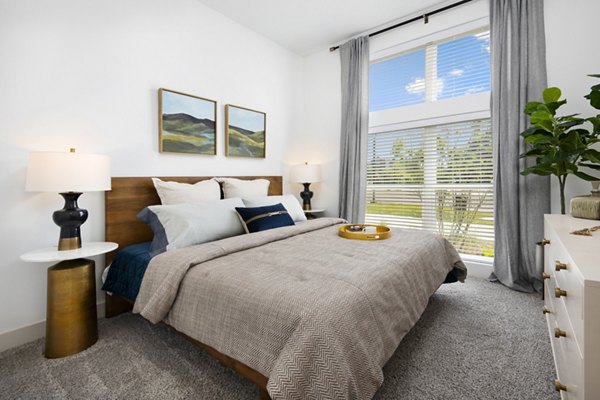 Tranquil bedroom with large windows and modern decor at Everleigh Vernon Hills Apartments