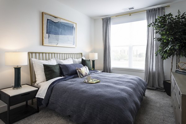 Spacious bedroom with modern decor in Everleigh Vernon Hills Apartments, a luxury living community