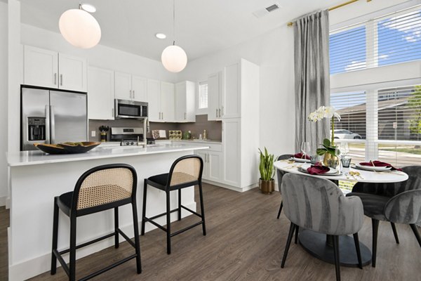 Dining area with elegant furnishings at Everleigh Vernon Hills Apartments featuring modern decor and ample natural light