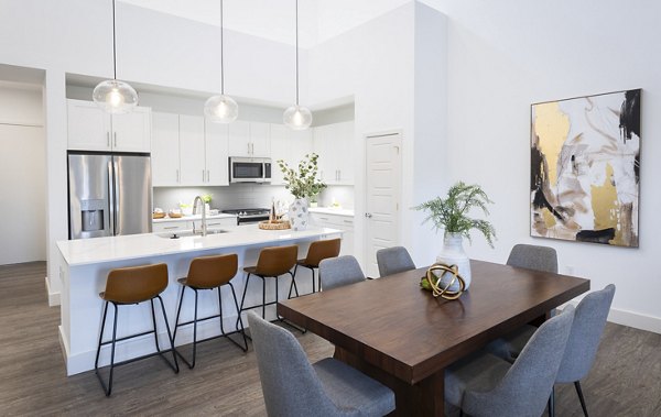 Dining area featuring elegant wood finishes and modern lighting at Everleigh Vernon Hills Apartments