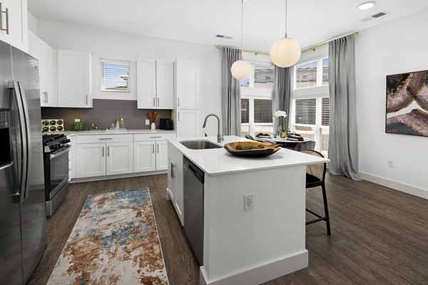 Modern kitchen with stainless steel appliances at Everleigh Vernon Hills Apartments