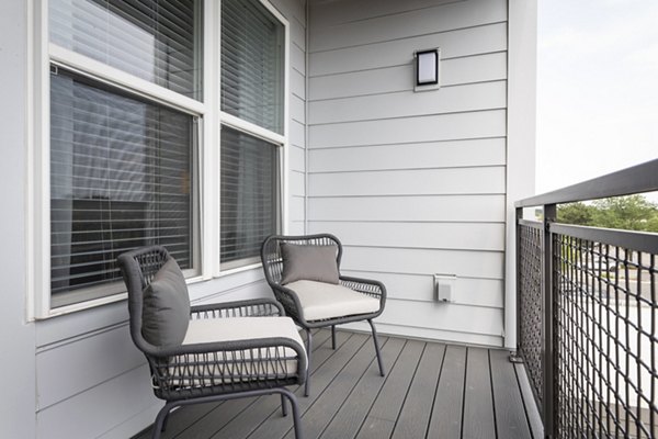 Patio with modern furniture and potted plants at Everleigh Vernon Hills Apartments