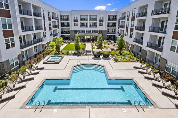 Infinity pool with lounge seating at Everleigh Vernon Hills Apartments