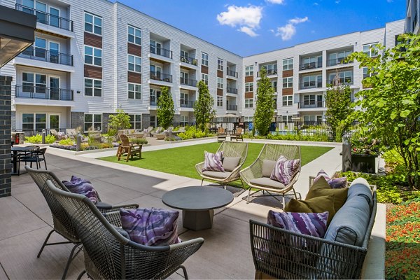 Tranquil courtyard with lush greenery at Everleigh Vernon Hills Apartments, ideal for relaxation and community gatherings