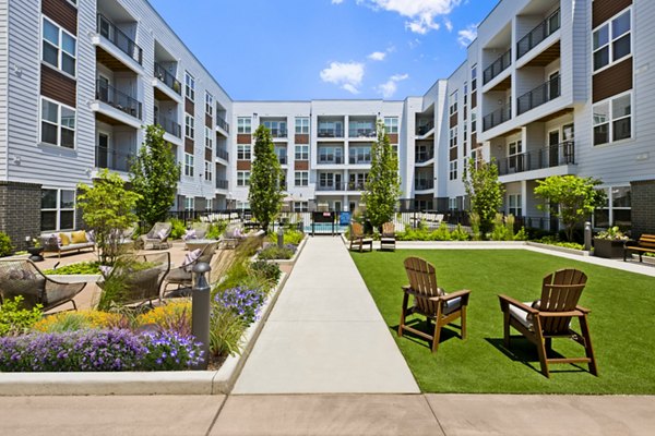 Courtyard featuring lush landscaping and seating areas at Everleigh Vernon Hills Apartments