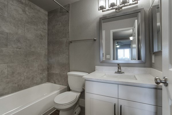 Elegant bathroom featuring marble countertops and sleek fixtures at Avana Cordoba Apartments