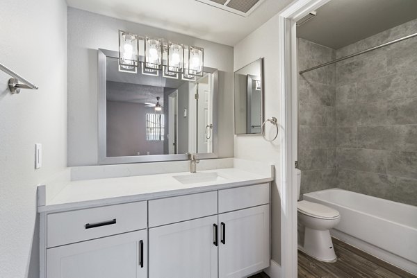 Bathroom with elegant fixtures and marble countertops at Avana Cordoba Apartments, a Greystar luxury apartment community
