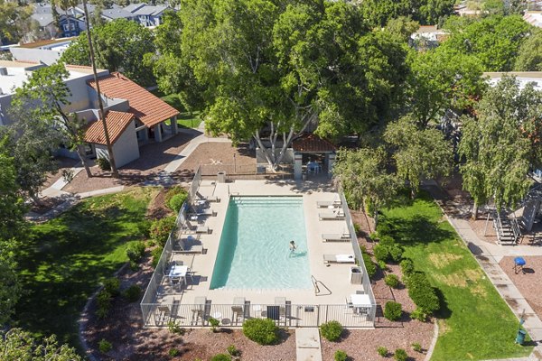 Tranquil pool area with lounge chairs at Avana Cordoba Apartments