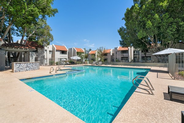 Luxurious poolside setting at Avana Cordoba Apartments with sun loungers and lush greenery
