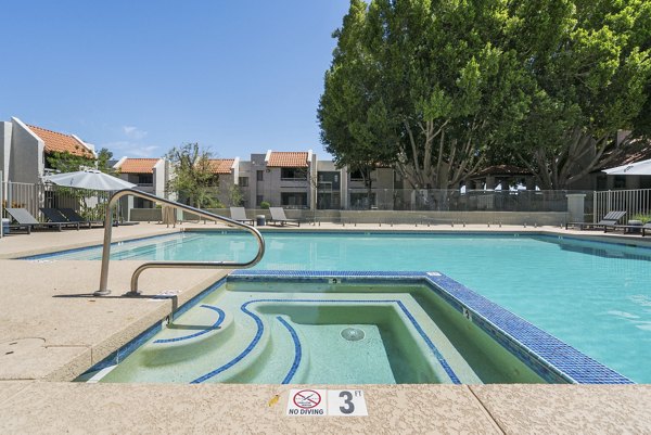 Inviting outdoor pool at Avana Cordoba Apartments with sun loungers and landscaped surroundings for luxury living