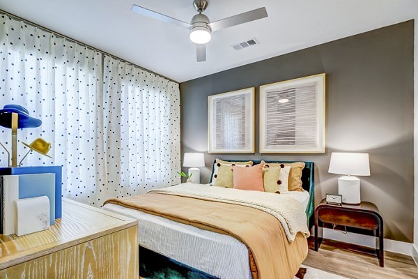 Bedroom with modern furnishings and ample natural light in Encore Motif Apartments