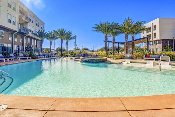 Relaxing outdoor pool area at Encore Motif Apartments, perfect for sunny days and leisure activities, featuring luxury amenities in heart of the city