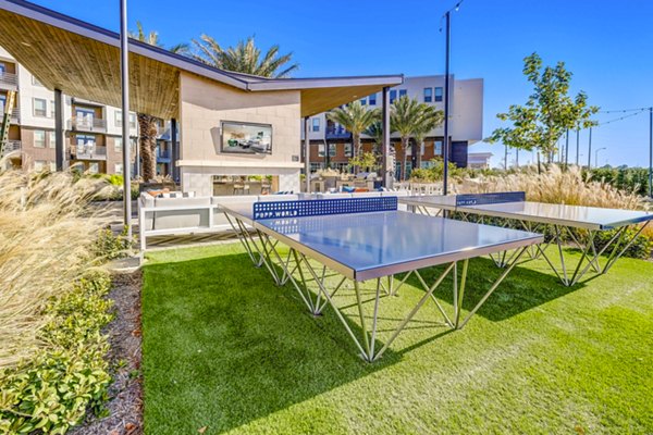 Outdoor recreational area with lush greenery and seating at Encore Motif Apartments â€“ ideal for relaxation and socializing in a luxury setting