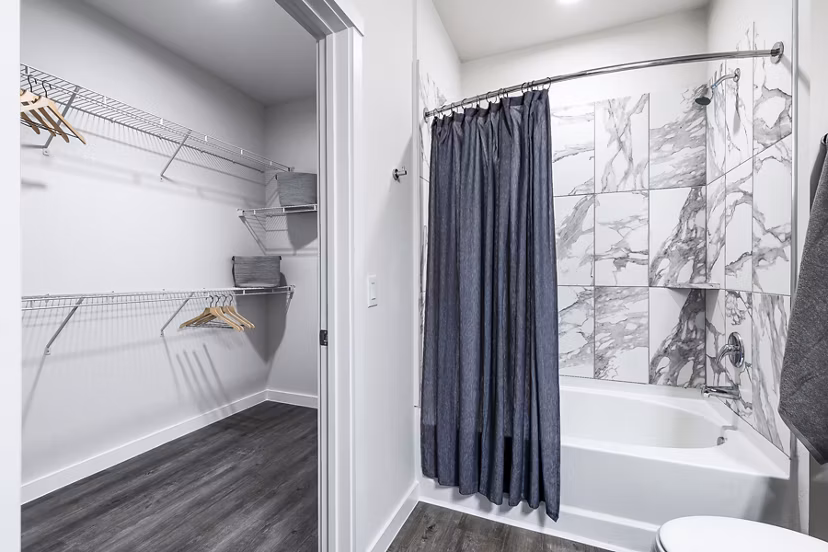 Modern bathroom with elegant vanity and large mirror at Prose Manor Apartments