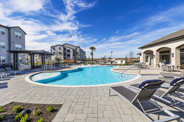 Resort-style pool with palm trees at Prose Manor Apartments