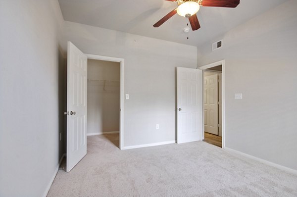 Bedroom with modern furnishings and soft lighting at Siena Apartments