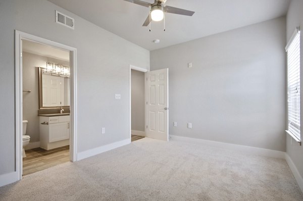 Cozy modern bedroom with sleek furnishings at Siena Apartments, showcasing luxury living