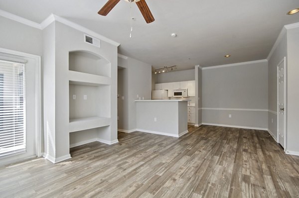 Spacious living room with designer furniture and natural light in Siena Apartments