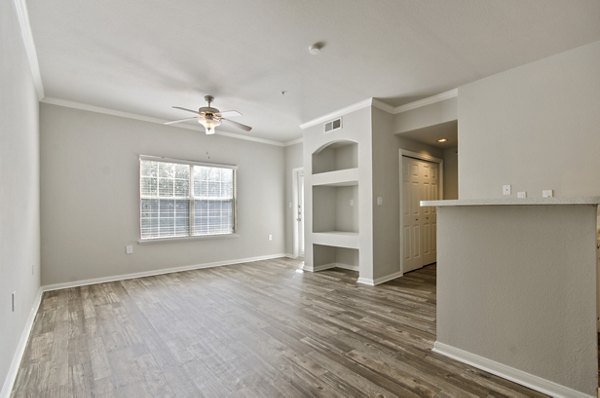 Contemporary living room with modern decor and ample natural light at Siena Apartments