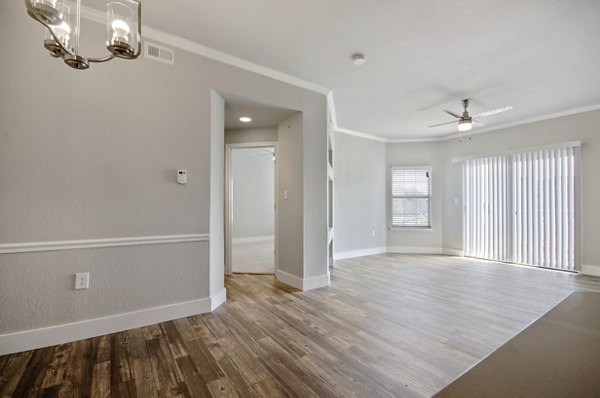 Spacious living room with modern decor and natural light in Siena Apartments