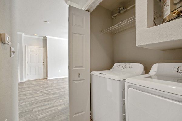 Laundry room equipped with modern washers and dryers at Siena Apartments