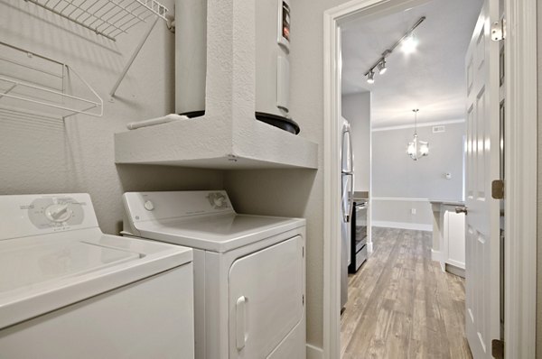 Laundry room with energy-efficient washers and dryers at Siena Apartments