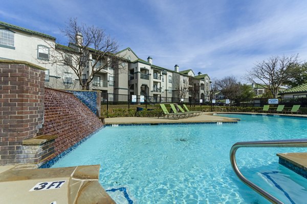 Resort-style pool surrounded by lush greenery at Siena Apartments, offering luxury amenities for relaxation and leisure