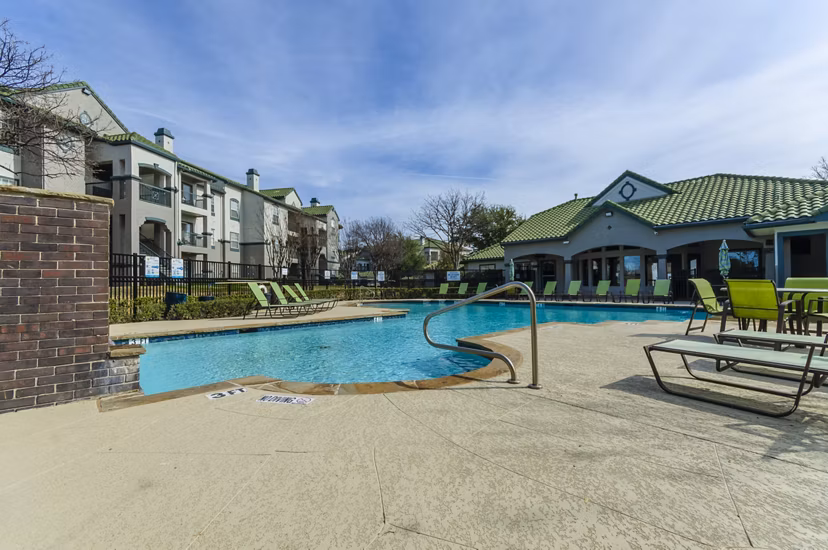 Rooftop pool with lounge chairs at Siena Apartments