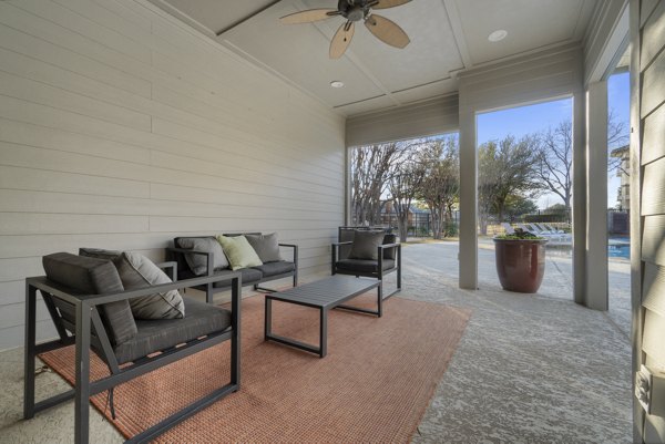 Spacious outdoor patio with modern seating at Siena Apartments, perfect for relaxation and social gatherings
