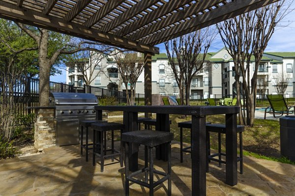 Grill area with modern BBQ stations at Siena Apartments, a luxury oasis for outdoor cooking and relaxation
