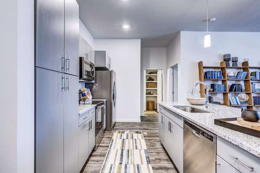 Stylish kitchen with modern appliances and sleek cabinetry at Polaris Junction Apartments