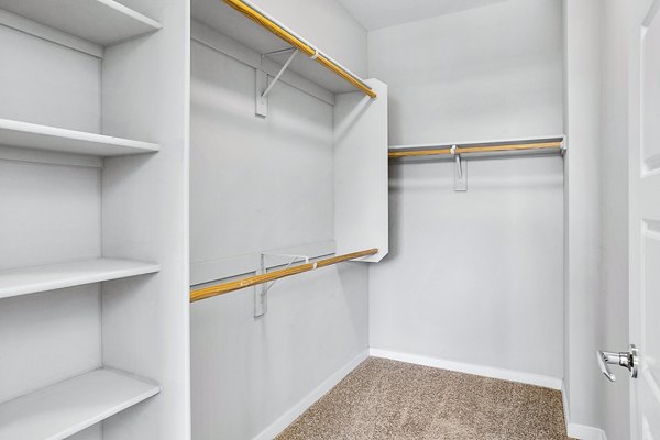 Sleek modern closet with ample storage in 601 PAX Apartments bedroom