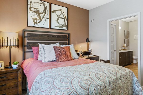 Bedroom with modern furnishings at 601 PAX Apartments