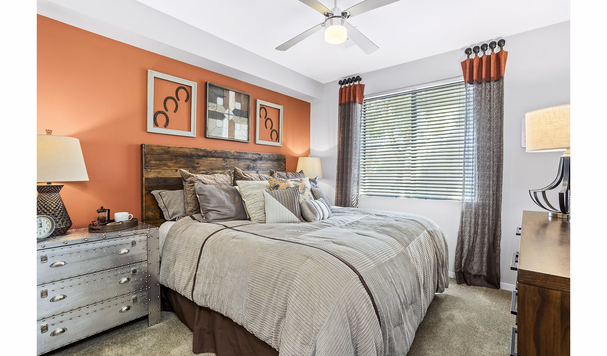 Cozy bedroom with modern decor and ample natural light at 601 PAX Apartments, a luxury Greystar property