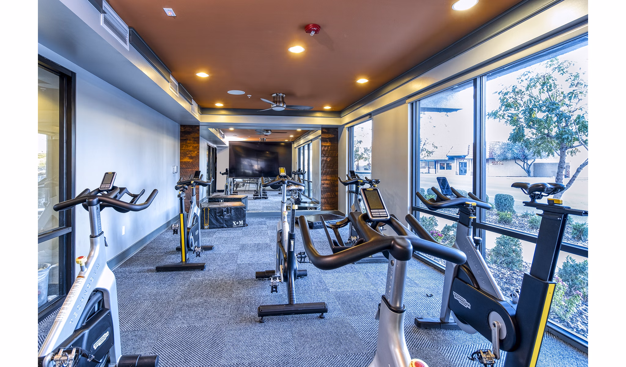 Modern spin studio with state-of-the-art bikes at 601 PAX Apartments offering luxury fitness amenities for residents