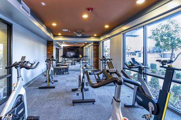 Modern spin studio with state-of-the-art bikes at 601 PAX Apartments offering luxury fitness amenities for residents