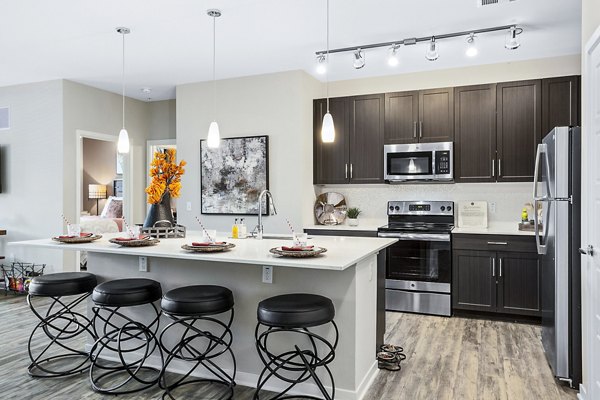 Kitchen featuring modern appliances and sleek countertops at 601 PAX Apartments, a Greystar luxury residence in the heart of vibrant city living